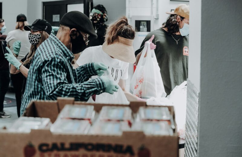 Volunteers standing beside stacked donation boxes