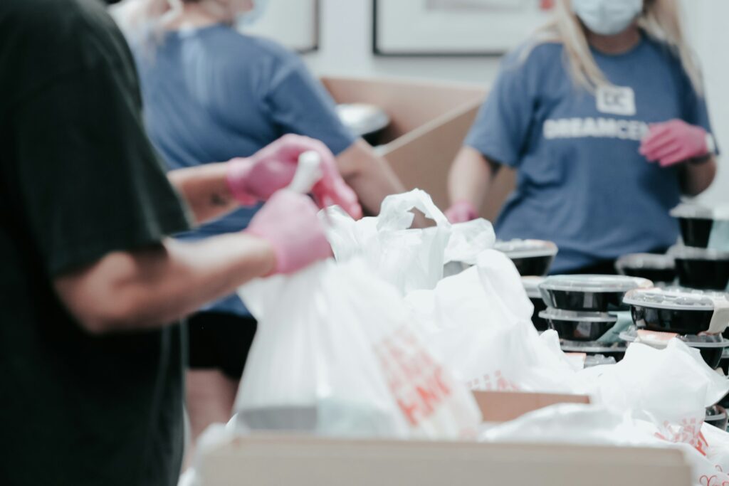 Volunteers packing groceries into bags for families
