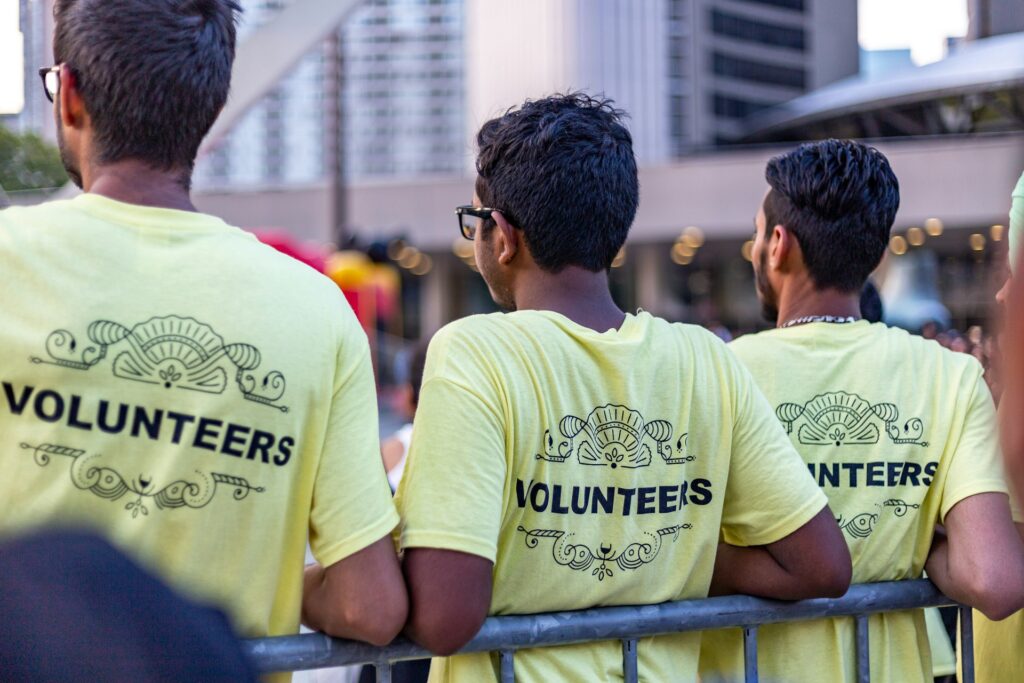 Three volunteers in matching volunteer shirts